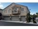 Townhome with multi-car garage, second story balcony, and tasteful desert landscaping at 9078 Camp Light Ave # 102, Las Vegas, NV 89149