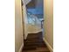 Hallway with hardwood floors leading to stairway with white banister at 9078 Camp Light Ave # 102, Las Vegas, NV 89149