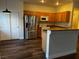Eat-in kitchen with stainless steel appliances, wood cabinets, and hardwood floors at 9078 Camp Light Ave # 102, Las Vegas, NV 89149