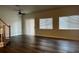 Bright living room features hard wood floors, stairs, and a ceiling fan at 9078 Camp Light Ave # 102, Las Vegas, NV 89149