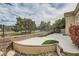 An eye-level shot of the backyard featuring a large concrete patio and lush landscaping at 916 Pro Players Dr, Las Vegas, NV 89134