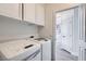 Bright laundry room with white cabinets and modern washer and dryer units at 916 Pro Players Dr, Las Vegas, NV 89134