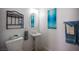 This is a half bathroom with pedestal sink, decorative artwork and white walls at 9277 Valley Ranch Ave, Las Vegas, NV 89178