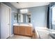 This primary bathroom features dual sinks, a large mirror, and a soaking tub with natural light at 9277 Valley Ranch Ave, Las Vegas, NV 89178