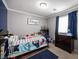 This bedroom features a playful decor, gray walls, crown molding, and a sunny window at 9277 Valley Ranch Ave, Las Vegas, NV 89178