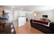 Open concept living room showing hardwood floors, staircase and open to the kitchen at 9277 Valley Ranch Ave, Las Vegas, NV 89178