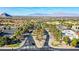 Panoramic aerial view showcases the community with mature trees, desert landscaping and mountain views at 9305 Quail Ridge Dr, Las Vegas, NV 89134