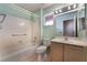 Bright bathroom with a shower over the tub, neutral color palette, and ample vanity counter space at 9305 Quail Ridge Dr, Las Vegas, NV 89134