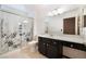 A functional bathroom features a vanity and shower with a floral pattern at 9305 Quail Ridge Dr, Las Vegas, NV 89134