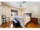 A light and airy bedroom with hardwood floors, a large window, and furnishings at 9305 Quail Ridge Dr, Las Vegas, NV 89134