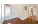 Bright entryway with a white door, modern rug, and gleaming hardwood floors at 9305 Quail Ridge Dr, Las Vegas, NV 89134