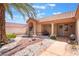 Inviting front entrance with a cozy seating area, desert landscaping, and a charming water feature at 9305 Quail Ridge Dr, Las Vegas, NV 89134