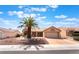 Charming single-story home with a well-manicured front yard and a mature palm tree, set under a bright blue sky at 9305 Quail Ridge Dr, Las Vegas, NV 89134