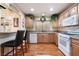 Cozy kitchen with wood cabinets, granite counters and bar seating at 9305 Quail Ridge Dr, Las Vegas, NV 89134