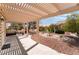 Charming covered patio with a pergola, creating a perfect spot for outdoor relaxation at 9305 Quail Ridge Dr, Las Vegas, NV 89134
