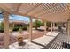 Inviting covered patio with landscaped grounds and stone accents at 9305 Quail Ridge Dr, Las Vegas, NV 89134