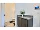 Powder room featuring granite counters, decorative plant, and modern fixtures at 10650 Sariah Skye Ave, Las Vegas, NV 89166