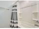 Bright bathroom featuring a tub and shower with a shower curtain, and built-in shelving at 10650 Sariah Skye Ave, Las Vegas, NV 89166