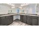 Bathroom with a double sink vanity and modern gray cabinetry at 10650 Sariah Skye Ave, Las Vegas, NV 89166