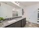 Well-lit bathroom with granite countertops, under-mount sink, tile flooring, and shower with curtain at 10650 Sariah Skye Ave, Las Vegas, NV 89166