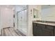 The bathroom features a glass-enclosed shower, gray cabinets, and granite countertops at 10650 Sariah Skye Ave, Las Vegas, NV 89166
