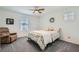 Cozy bedroom with plush carpeting, a recliner, ceiling fan and a window for natural light at 10650 Sariah Skye Ave, Las Vegas, NV 89166