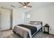 Bright bedroom featuring a ceiling fan, neutral walls, comfortable carpeting and a closet at 10650 Sariah Skye Ave, Las Vegas, NV 89166