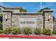 Stone Ravenna community sign with manicured landscaping and bright red curb at 10650 Sariah Skye Ave, Las Vegas, NV 89166