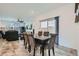 View of dining room adjacent to the living room, featuring modern decor, and a sliding glass door at 10650 Sariah Skye Ave, Las Vegas, NV 89166
