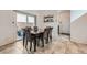 The dining room features a sliding glass door and seating for six around a dark wood table at 10650 Sariah Skye Ave, Las Vegas, NV 89166