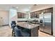 Modern kitchen boasts stainless steel appliances, granite countertops, and an island with seating at 10650 Sariah Skye Ave, Las Vegas, NV 89166