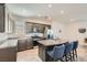 This kitchen features granite countertops, stainless steel appliances, and an island with barstool seating at 10650 Sariah Skye Ave, Las Vegas, NV 89166