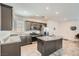 Open kitchen with island, modern appliances, and neutral color scheme at 10650 Sariah Skye Ave, Las Vegas, NV 89166