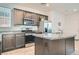 Modern kitchen features stainless appliances, granite counters, and center island at 10650 Sariah Skye Ave, Las Vegas, NV 89166