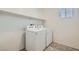 Functional laundry room featuring a washer, dryer, overhead shelving, and vinyl floors at 10650 Sariah Skye Ave, Las Vegas, NV 89166