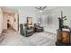 Relaxing living area with plush carpets, ceiling fan and a view of the entryway at 10650 Sariah Skye Ave, Las Vegas, NV 89166