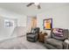 Open living area with plush carpeting, ceiling fan and modern decor for a relaxing atmosphere at 10650 Sariah Skye Ave, Las Vegas, NV 89166