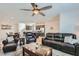 Open-concept living area with tile floors, ceiling fan, and modern furnishings at 10650 Sariah Skye Ave, Las Vegas, NV 89166