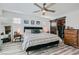 Light filled main bedroom showcases wood-look floors, a ceiling fan, and a closet with sliding barn doors at 10650 Sariah Skye Ave, Las Vegas, NV 89166