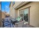 Back patio with a fire pit, outdoor seating, and sliding glass door at 10650 Sariah Skye Ave, Las Vegas, NV 89166