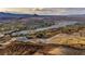 An aerial view shows the mountain, lake, and a sprawling desert community at 19 Hilltop Crest St, Henderson, NV 89011