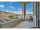 Balcony showcasing mountain views, a comfortable seating area, and sleek railings at 19 Hilltop Crest St, Henderson, NV 89011