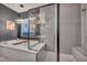 This bathroom has a soaking tub with a modern chandelier and a separate glass shower at 19 Hilltop Crest St, Henderson, NV 89011