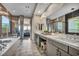 This bathroom boasts double vanities, modern lighting, and a separate soaking tub at 19 Hilltop Crest St, Henderson, NV 89011