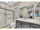 Modern bathroom featuring a tiled shower with glass door and a vanity with sleek cabinets at 19 Hilltop Crest St, Henderson, NV 89011