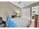 This bedroom features a stylish upholstered headboard, a ceiling fan, and wood-look floors at 19 Hilltop Crest St, Henderson, NV 89011