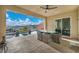 View of covered patio with outdoor dining area adjacent to the pool and landscape at 19 Hilltop Crest St, Henderson, NV 89011