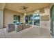 Covered patio with outdoor dining area and ceiling fan offers a relaxing retreat at 19 Hilltop Crest St, Henderson, NV 89011