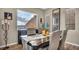 Elegant dining room featuring dark wood table, stylish seating, and a large window with a scenic view at 19 Hilltop Crest St, Henderson, NV 89011