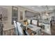 Modern dining area features a dark wood table, elegant seating, and a stylish granite kitchen island at 19 Hilltop Crest St, Henderson, NV 89011